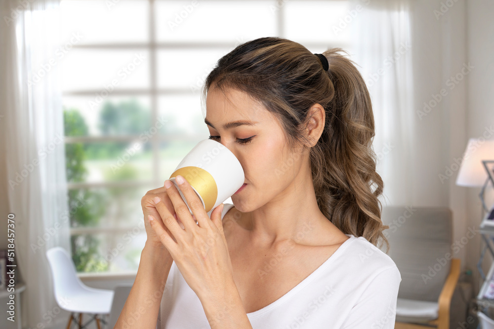 Woman sitting in coffee shop enjoying delicious taste of coffee Woman sitting in coffee shop enjoying delicious taste of coffee