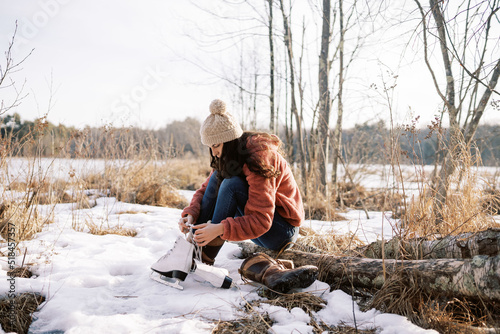 young woman tying her skates