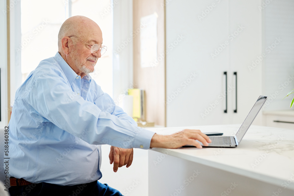 Aged freelancer browsing netbook Aged freelancer browsing netbook