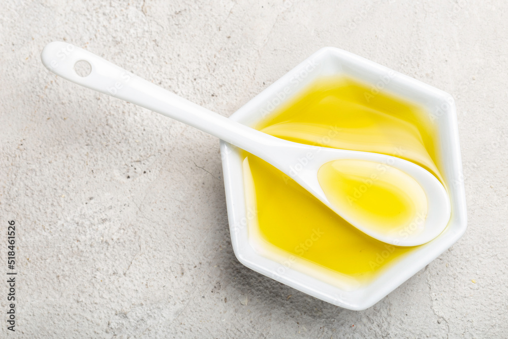 castor oil in spoon and white container, top view castor oil in spoon and white container, top view