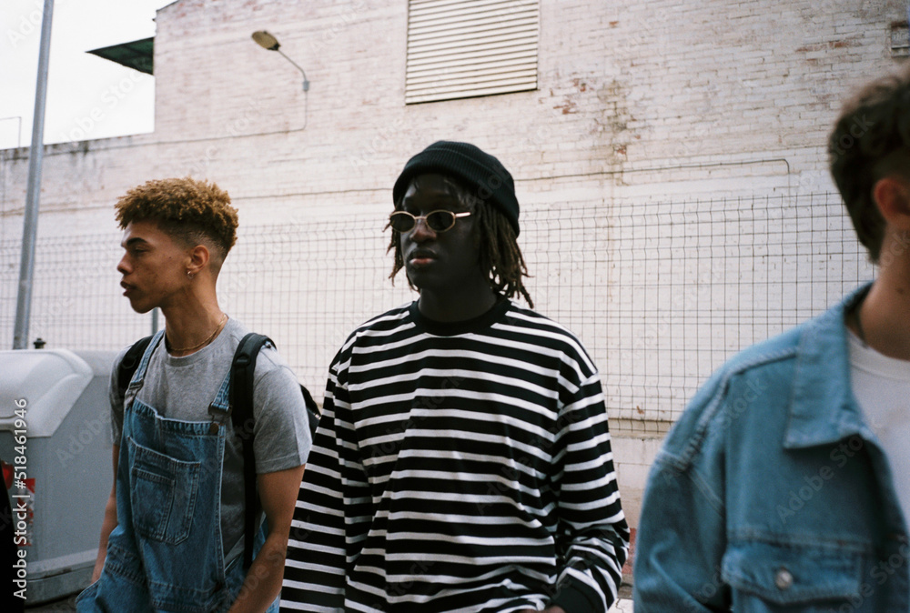 © BONNINSTUDIO/Stocksy - Diverse trendy youngsters on the street