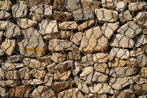 Rocks behind chicken wire photo