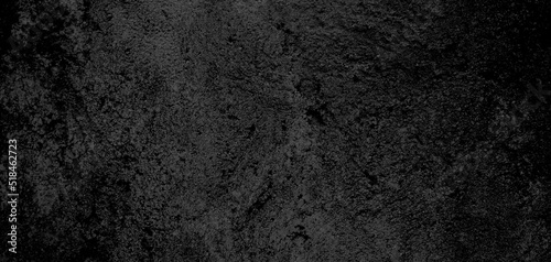 Dark black textured concrete stone wall abstract background. © Adam