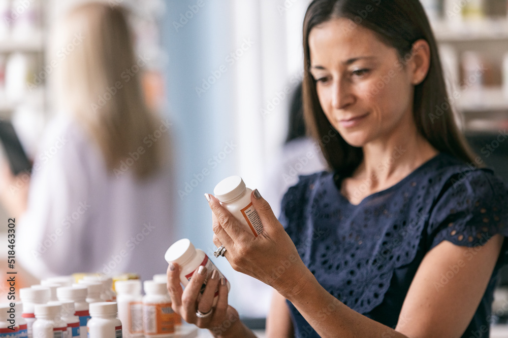 © Sean Locke/Stocksy - RX: Woman Comparing Two Medications