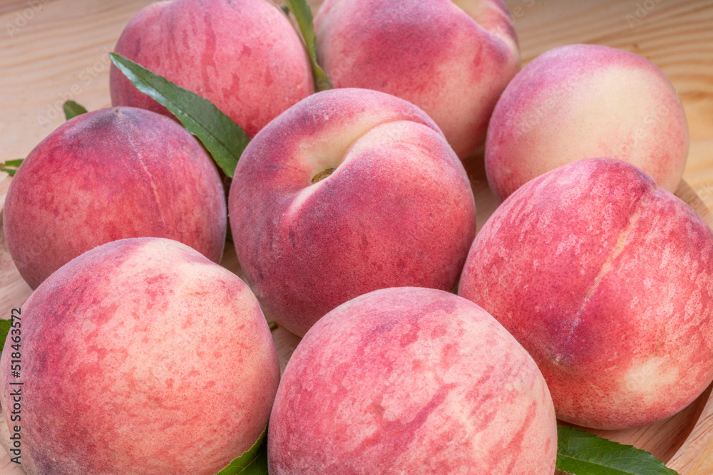 Fresh Sweet Peach on pink wooden background, Pink and yellow Peach fruit with leaf on bamboo basket. Fresh Sweet Peach on pink wooden background, Pink and yellow Peach fruit with leaf on bamboo basket.