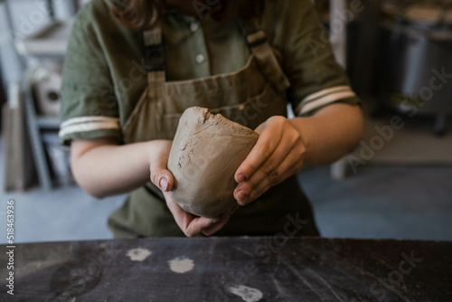 The creative process of creating a clay mug by a female ceramist photo