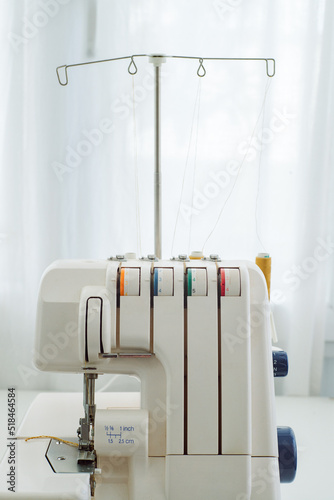 Sewing machines on the table in a home sewing studio photo