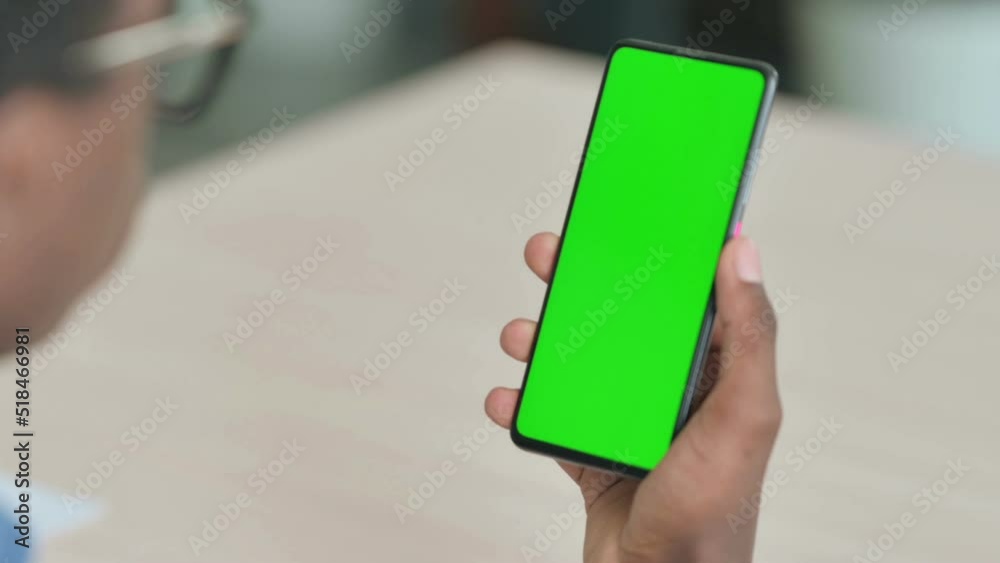 Close Up of Young African Man Using Smartphone with Green Screen Close Up of Young African Man Using Smartphone with Green Screen