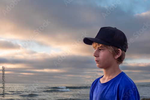 Teenage boy portrait with sunset seascape
