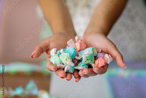 Crop hands holding taffy candies