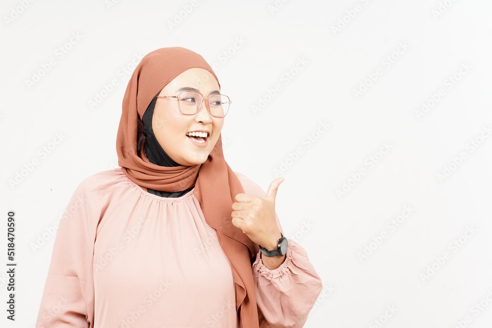 Presenting and Pointing Side Product Using Thumb of Beautiful Asian Woman Wearing Hijab Presenting and Pointing Side Product Using Thumb of Beautiful Asian Woman Wearing Hijab