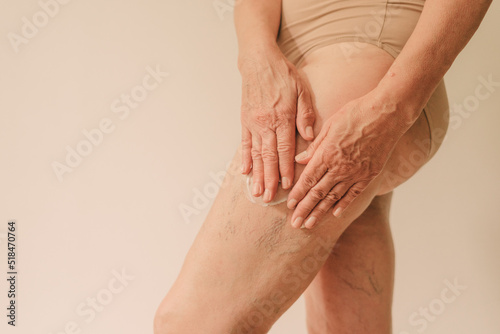 Woman moisturizing aged skin