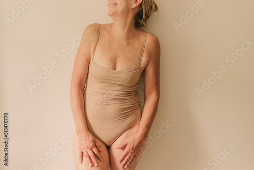 Crop natural positive woman in neutral bodysuit
