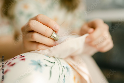 hand with thimble sewing photo