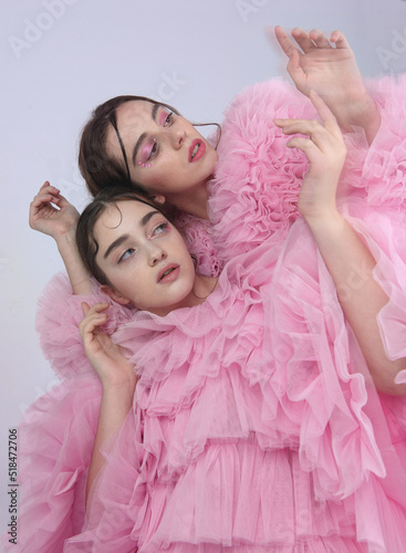 Two women in pink pastel color photo