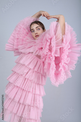 Cute woman in pink ruffle dress photo