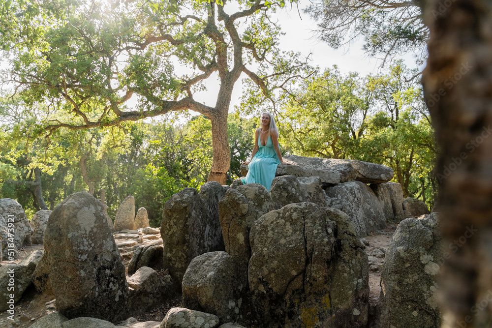 Woman sitting on rocks in the forest Woman sitting on rocks in the forest