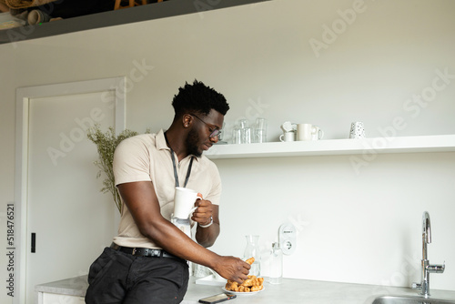 African worker having snack in office
