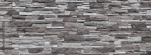 Grey with black texture of brickwork and stone wall for website background or for design, panoramic view