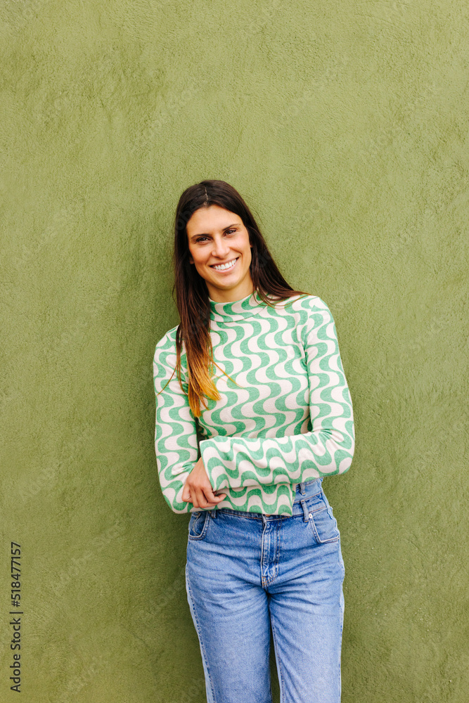 Smiling woman standing near wall Smiling woman standing near wall