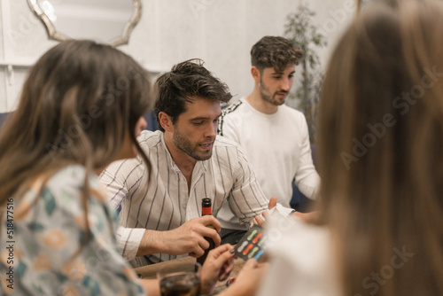 A cheerful group of friends play board games photo