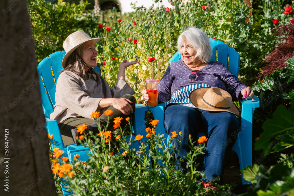 Happy women chatting at blooming garden Happy women chatting at blooming garden