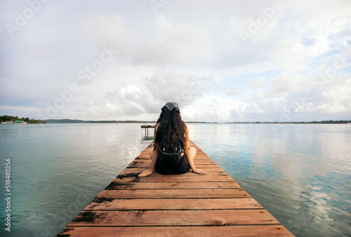 Beautiful shot of a woman alone on a wooden jetty
