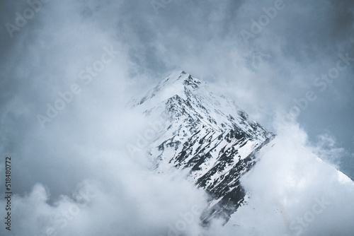 Mountain peak  in the fog photo