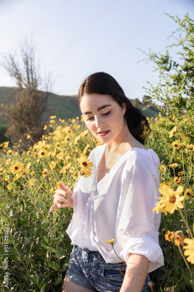 Attractive young woman in field of yellow flowers Attractive young woman in field of yellow flowers