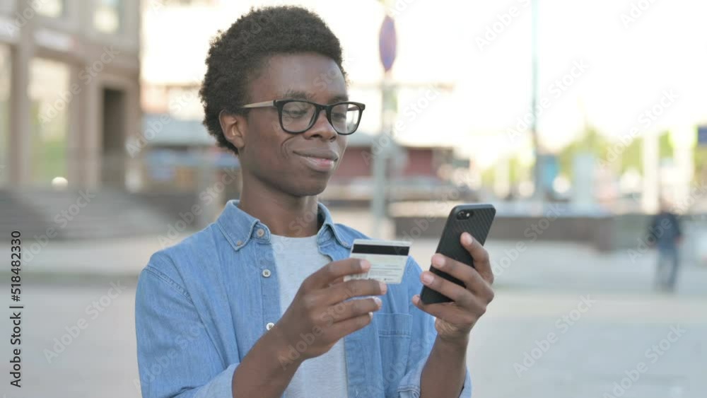 Excited Young African Man Shopping Online via Smartphone, Outdoor Excited Young African Man Shopping Online via Smartphone, Outdoor