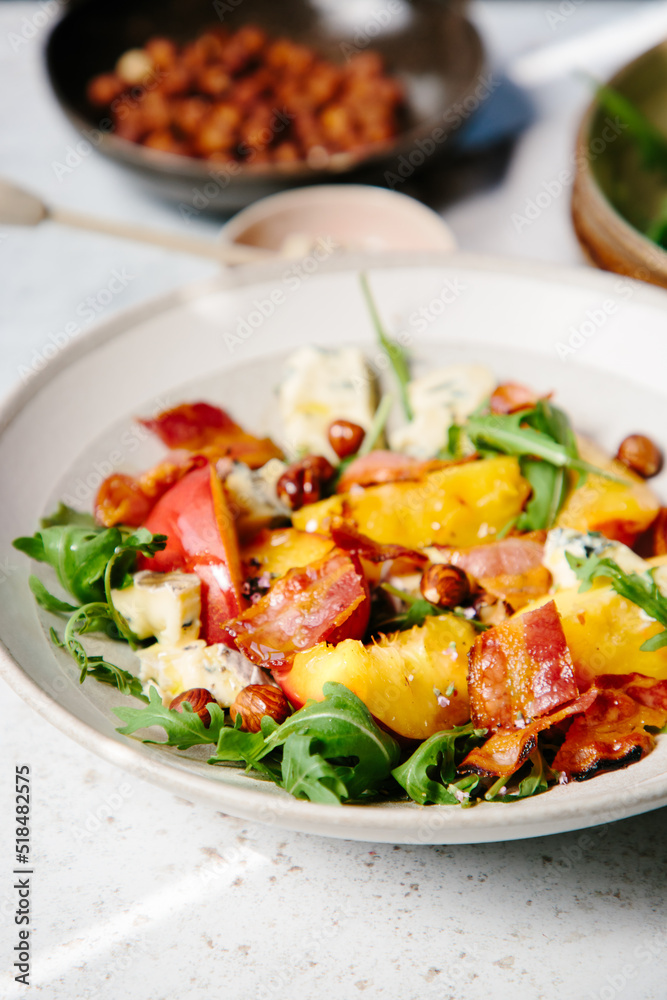 A dish of cooked peaches with blue cheese and bacon A dish of cooked peaches with blue cheese and bacon