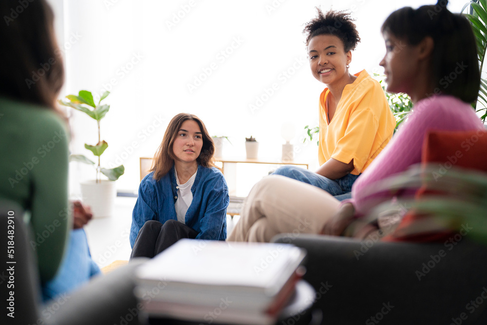 Multiracial women speaking in office together Multiracial women speaking in office together