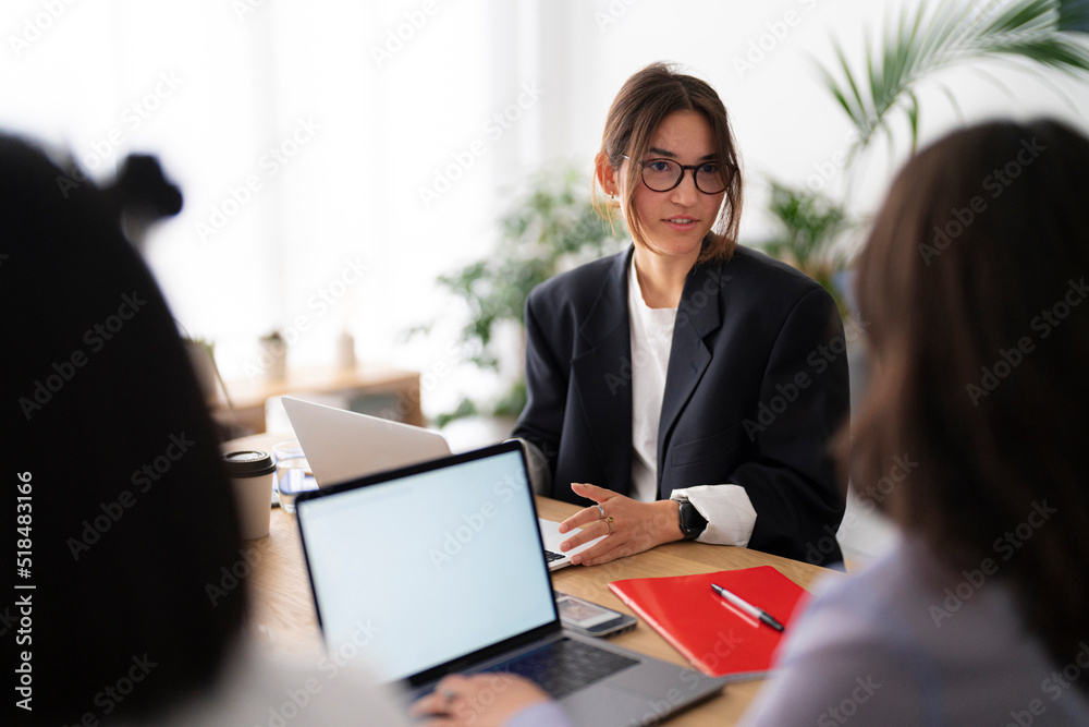 Project leader discussing data with coworker Project leader discussing data with coworker
