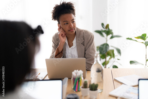 Thoughtful black designer during meeting