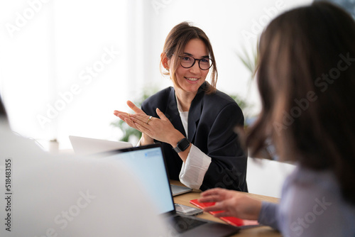 Project leader discussing data with coworker photo