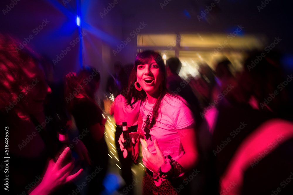 Cheerful woman having fun at night party Cheerful woman having fun at night party