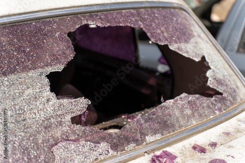 Bullet shattered rear window of a car photo