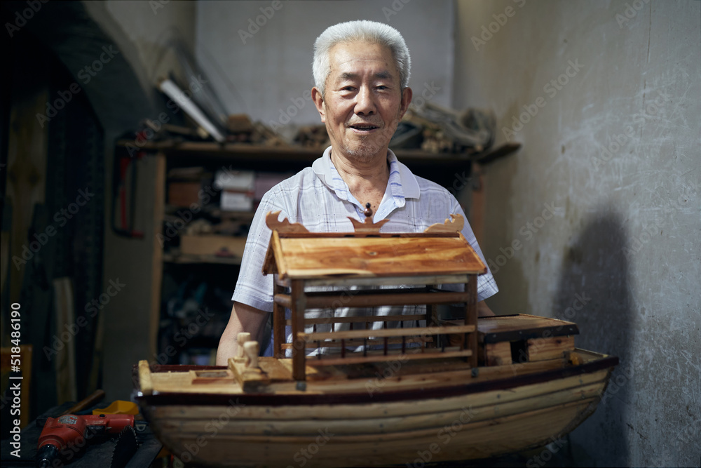 Older Asian Man Works On His Model Boats At His Workshop. Older Asian Man Works On His Model Boats At His Workshop.