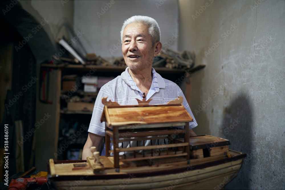 Older Asian Man Works On His Model Boats At His Workshop. Older Asian Man Works On His Model Boats At His Workshop.