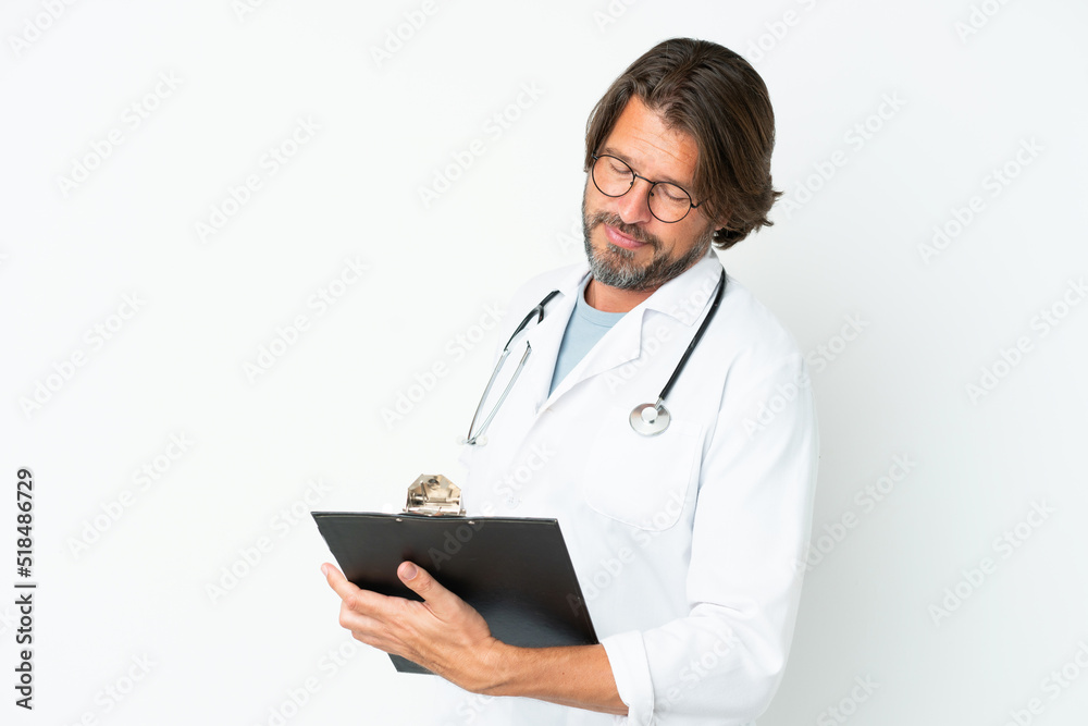 Senior dutch man isolated on white background wearing a doctor gown and holding a folder Senior dutch man isolated on white background wearing a doctor gown and holding a folder
