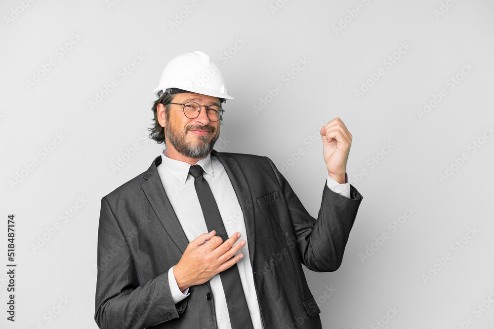 Young architect man with helmet over isolated background making guitar gesture