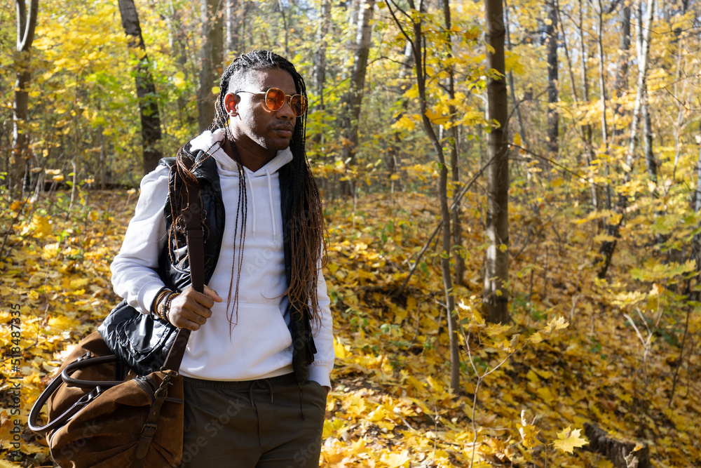 Man walking in the forest during an autumn afternoon Man walking in the forest during an autumn afternoon