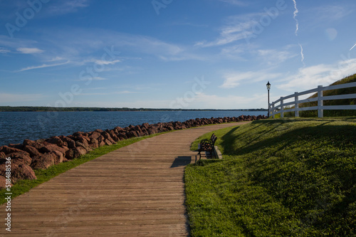 Wooden boardwalk along the waterfront with benches and street lights in Charlottetown, Prince Edward Island, Canada