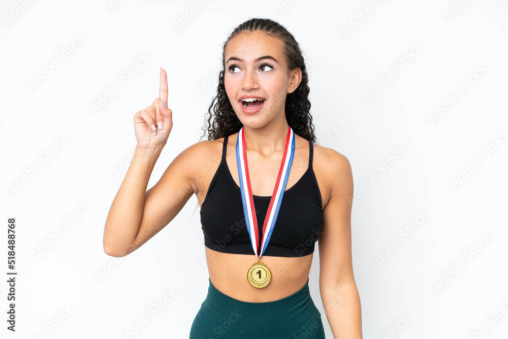 Young sport woman with medals isolated on white background intending to realizes the solution while lifting a finger up Young sport woman with medals isolated on white background intending to realizes the solution while lifting a finger up