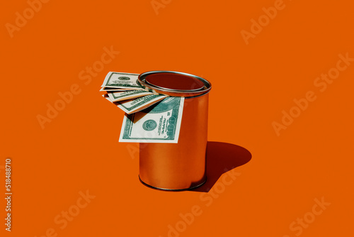 dollar bills in a tin can with lid photo