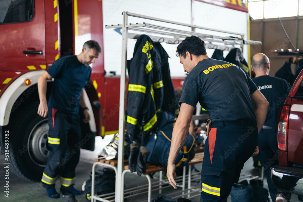 firefighters putting on the uniform to go to an emergency firefighters putting on the uniform to go to an emergency