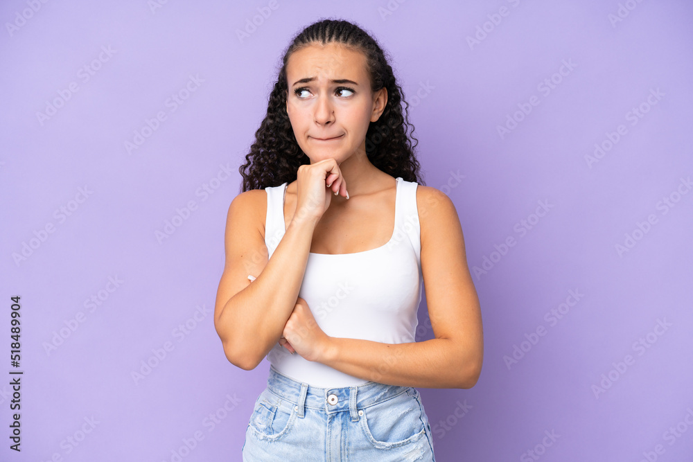 Young woman isolated on purple background having doubts and thinking Young woman isolated on purple background having doubts and thinking