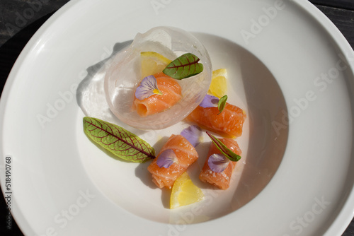 Salmon carpaccio with shio koji, yuzu juice, and olive oil in an ice sphere