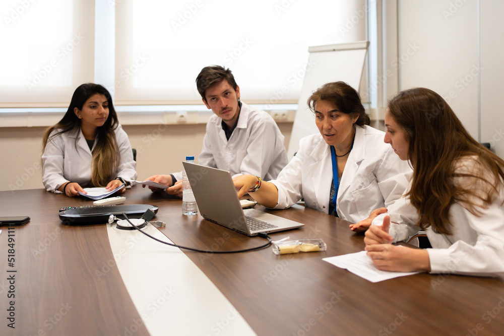 Meeting Of Scientists Discussing Sitting Around The Table. Meeting Of Scientists Discussing Sitting Around The Table.