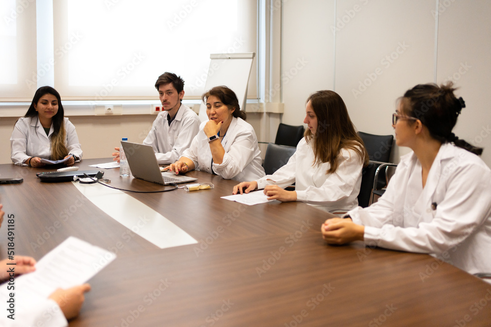 © Luis Velasco/Stocksy - Meeting Of Scientists Discussing Sitting Around The Table. © Luis Velasco/Stocksy - Meeting Of Scientists Discussing Sitting Around The Table.